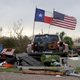 The Texas state flag and American flag wave in the wind over an area of debris left behind in the wake of Hurricane Harvey, Sunday, Aug. 27, 2017, in Rockport, Texas. (AP Photo/Eric Gay)